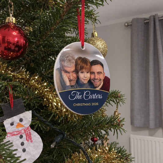 Midnight blue personalised family photo bauble hanging on a Christmas tree