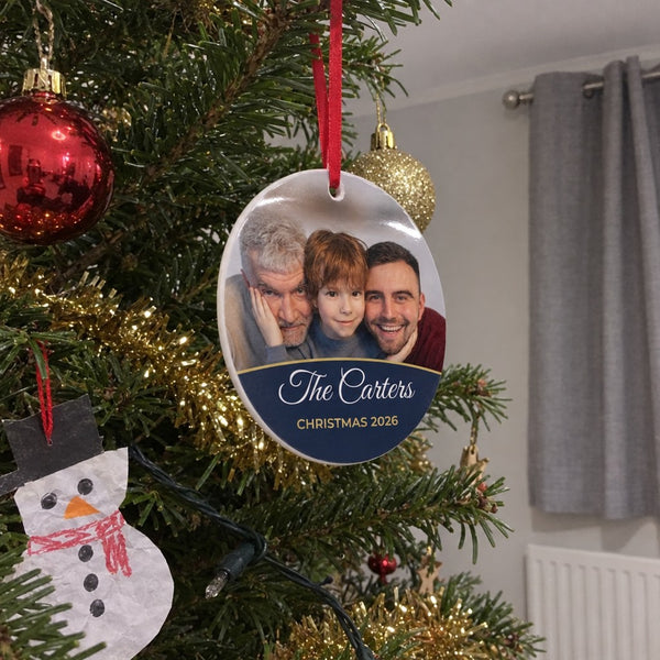 Midnight blue personalised family photo bauble hanging on a Christmas tree