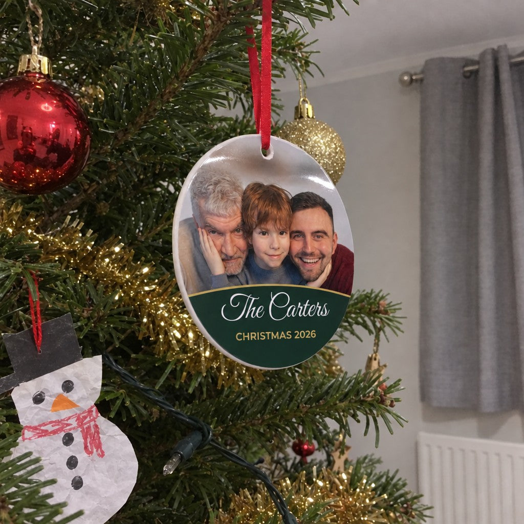Forest green personalised family photo bauble hanging on a Christmas tree