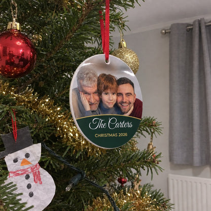 Forest green personalised family photo bauble hanging on a Christmas tree