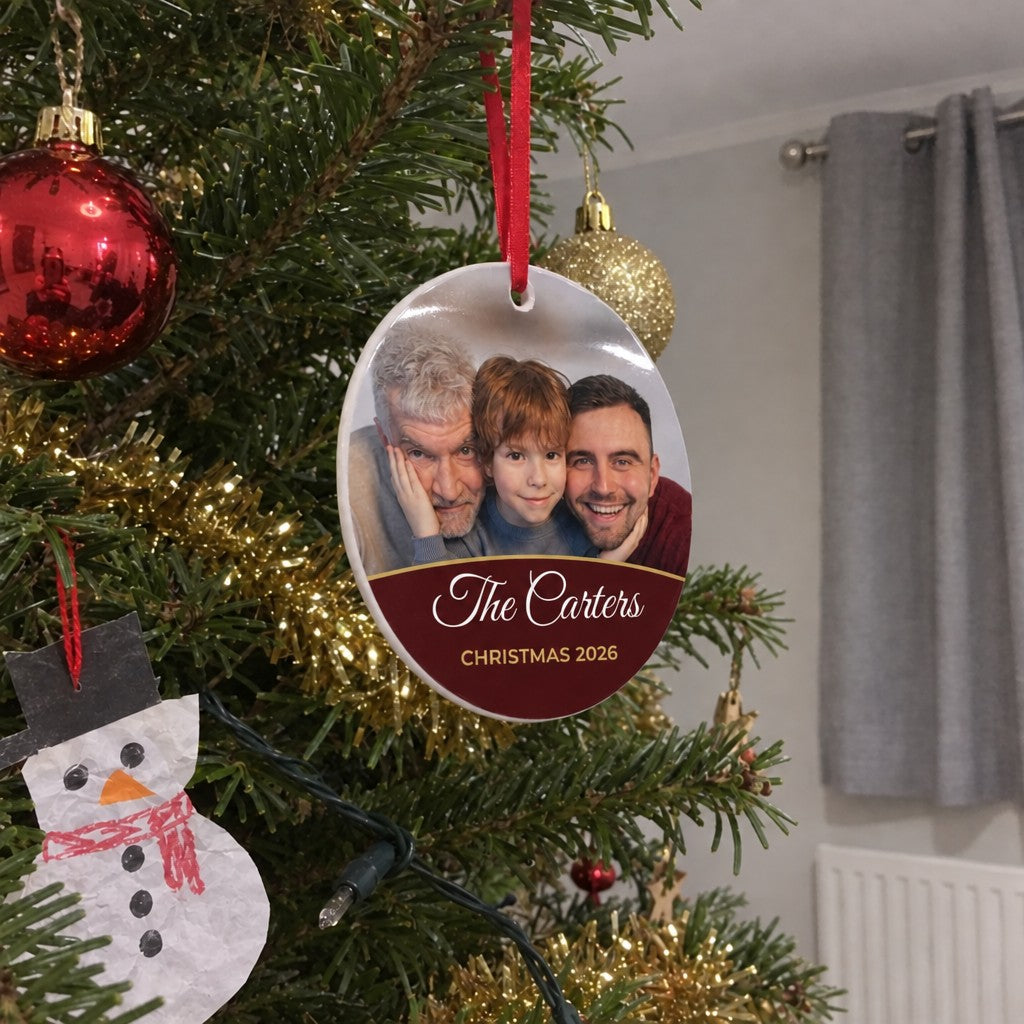Berry red personalised family photo bauble hanging on a Christmas tree