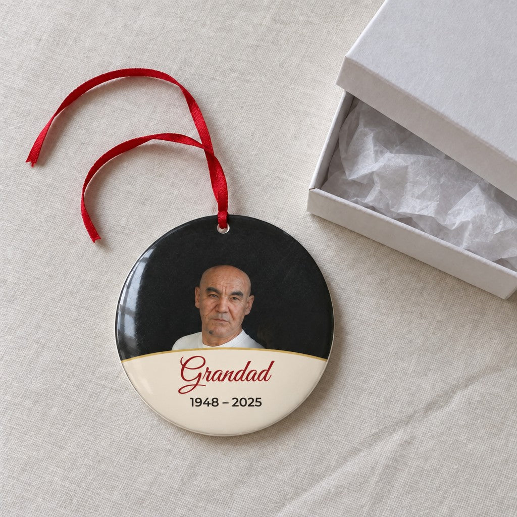 Cream personalised memorial photo bauble on a tablecloth beside a white gift box