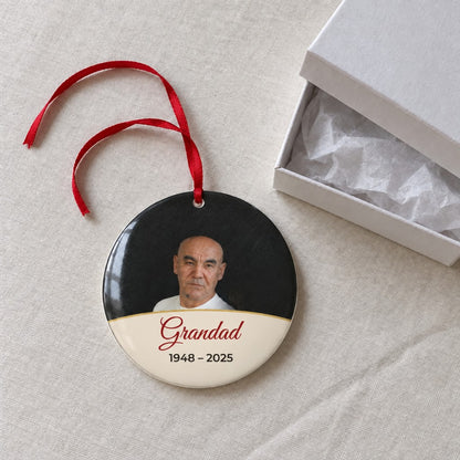 Cream personalised memorial photo bauble on a tablecloth beside a white gift box