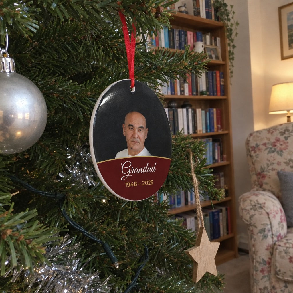 Berry red personalised memorial photo bauble hanging on a Christmas tree