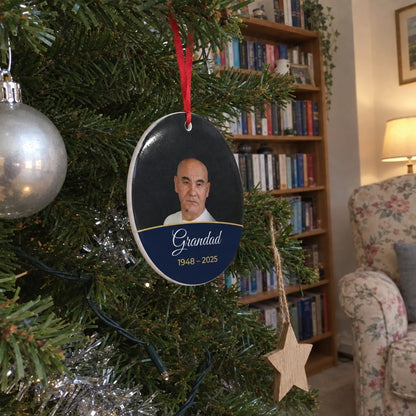Midnight blue personalised memorial photo bauble hanging on a Christmas tree