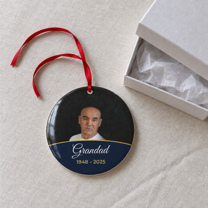 Midnight blue personalised memorial photo bauble on a tablecloth beside a white gift box