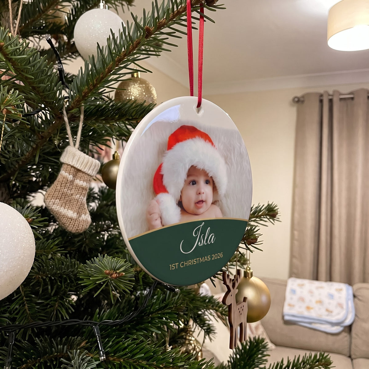 Forest green personalised Baby's 1st Christmas photo bauble hanging on a Christmas tree