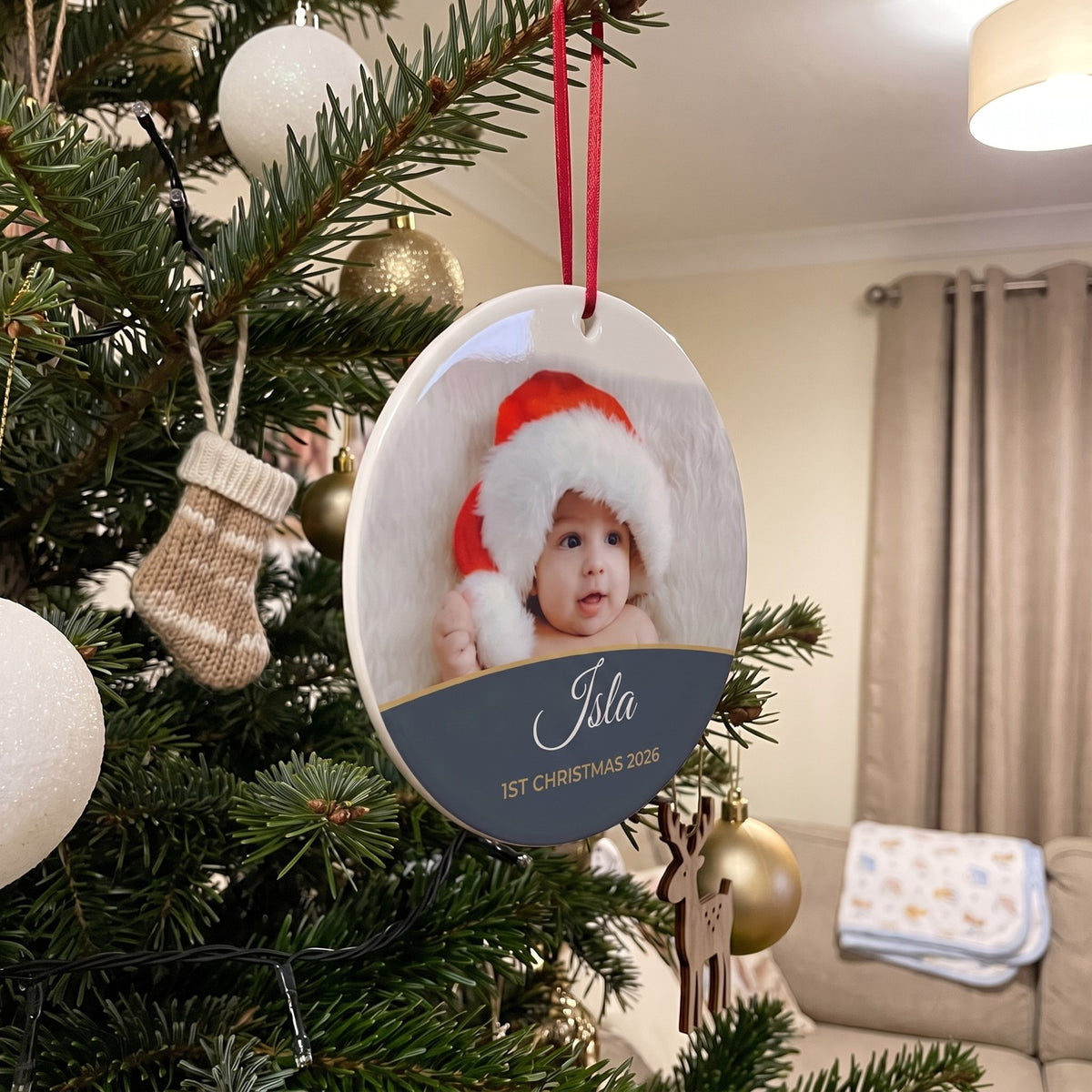 Slate personalised Baby's 1st Christmas photo bauble hanging on a Christmas tree