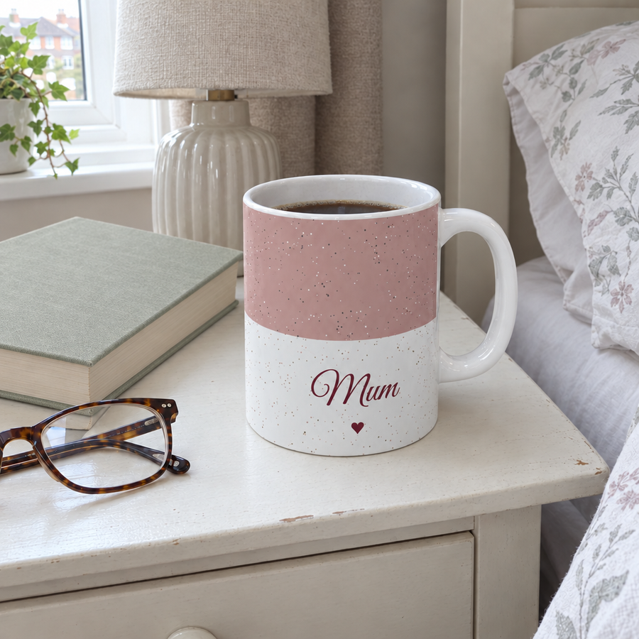 Dusty pink personalised name mug reading Mum on a bedside table